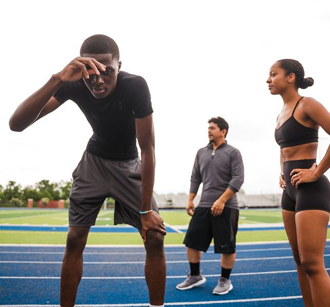Athletes stretching on track